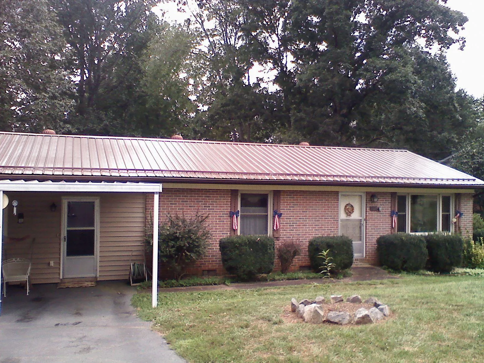 Bronze metal roof and carport on a brick ranch home — Roof Repair work by our crew in De Ruyter